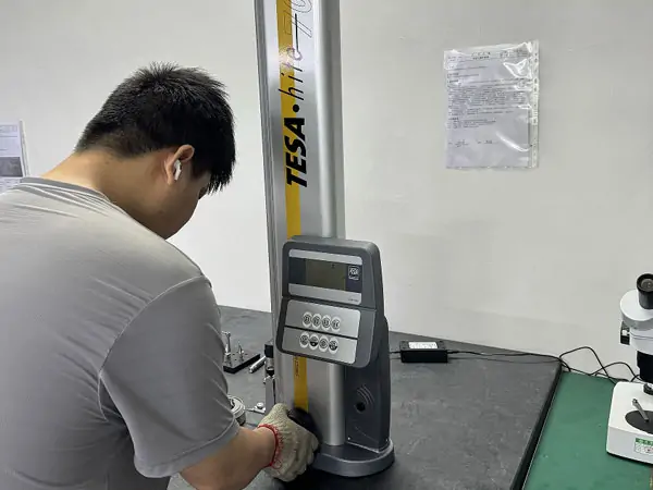 Operator performing CNC quality check using TESA height gauge for accurate dimensional inspection