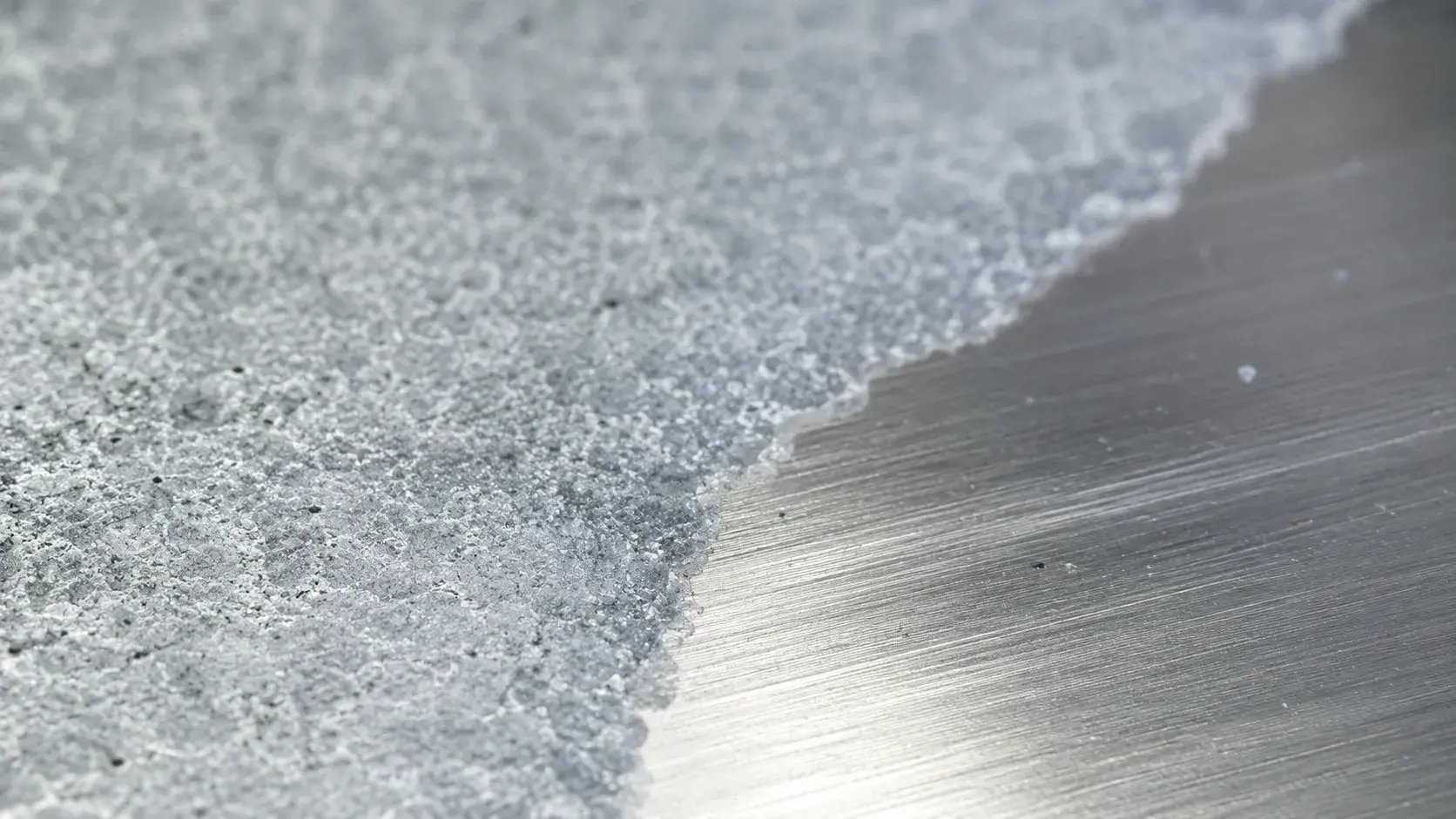 Close-up view of aluminum oxidation layer on metal surface