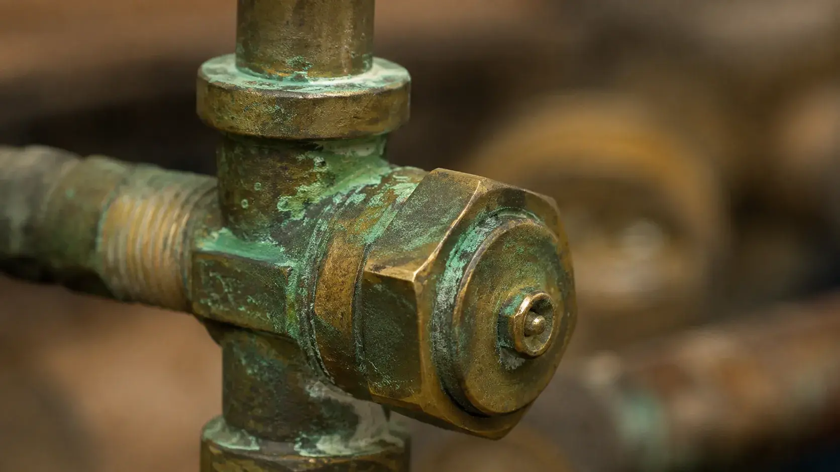 Green patina forming on brass surface due to oxidation